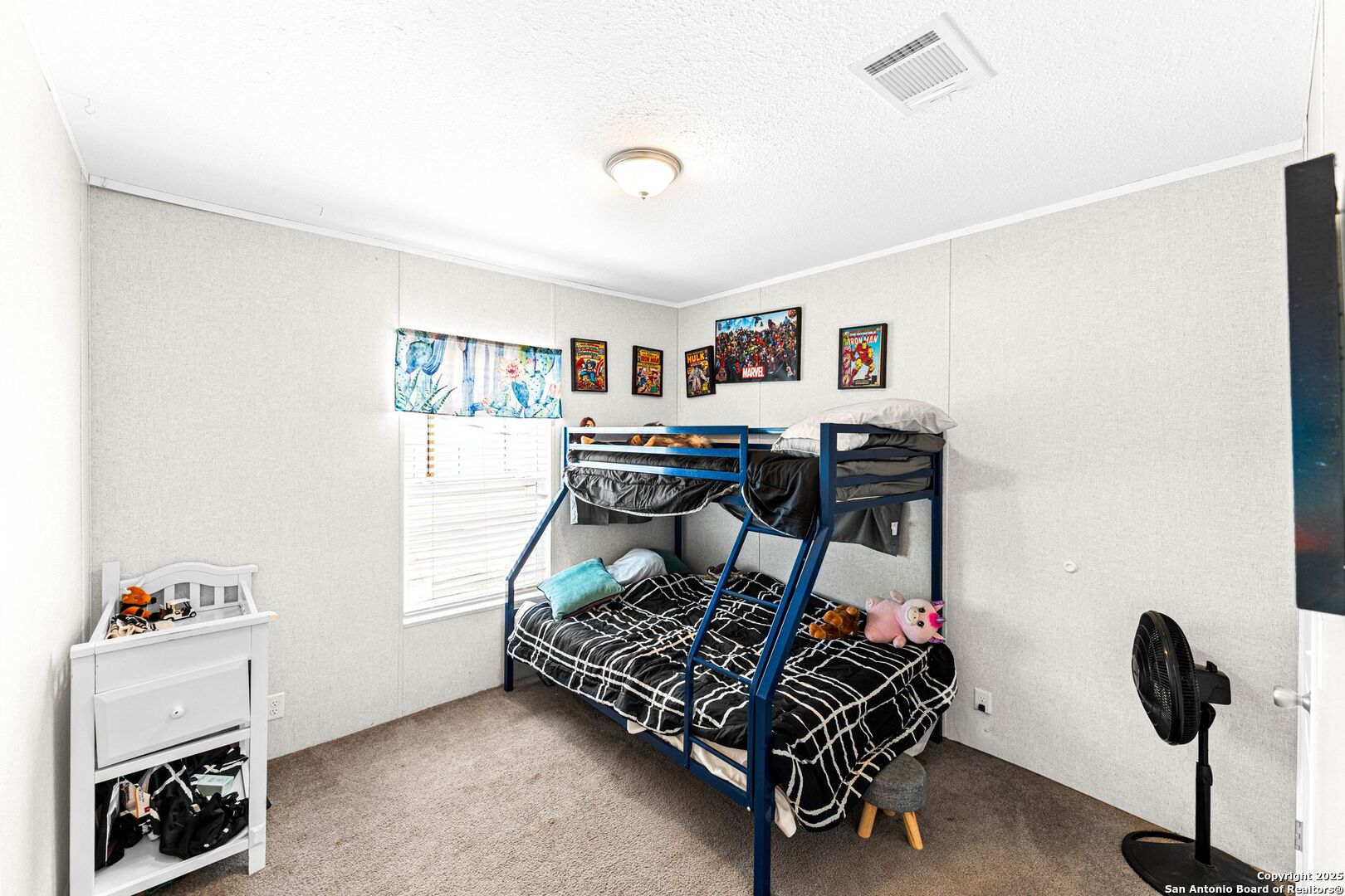 1979 County Road 651 Devine, TX 78016 - Photo 18 of 52 a bedroom with furniture and a window