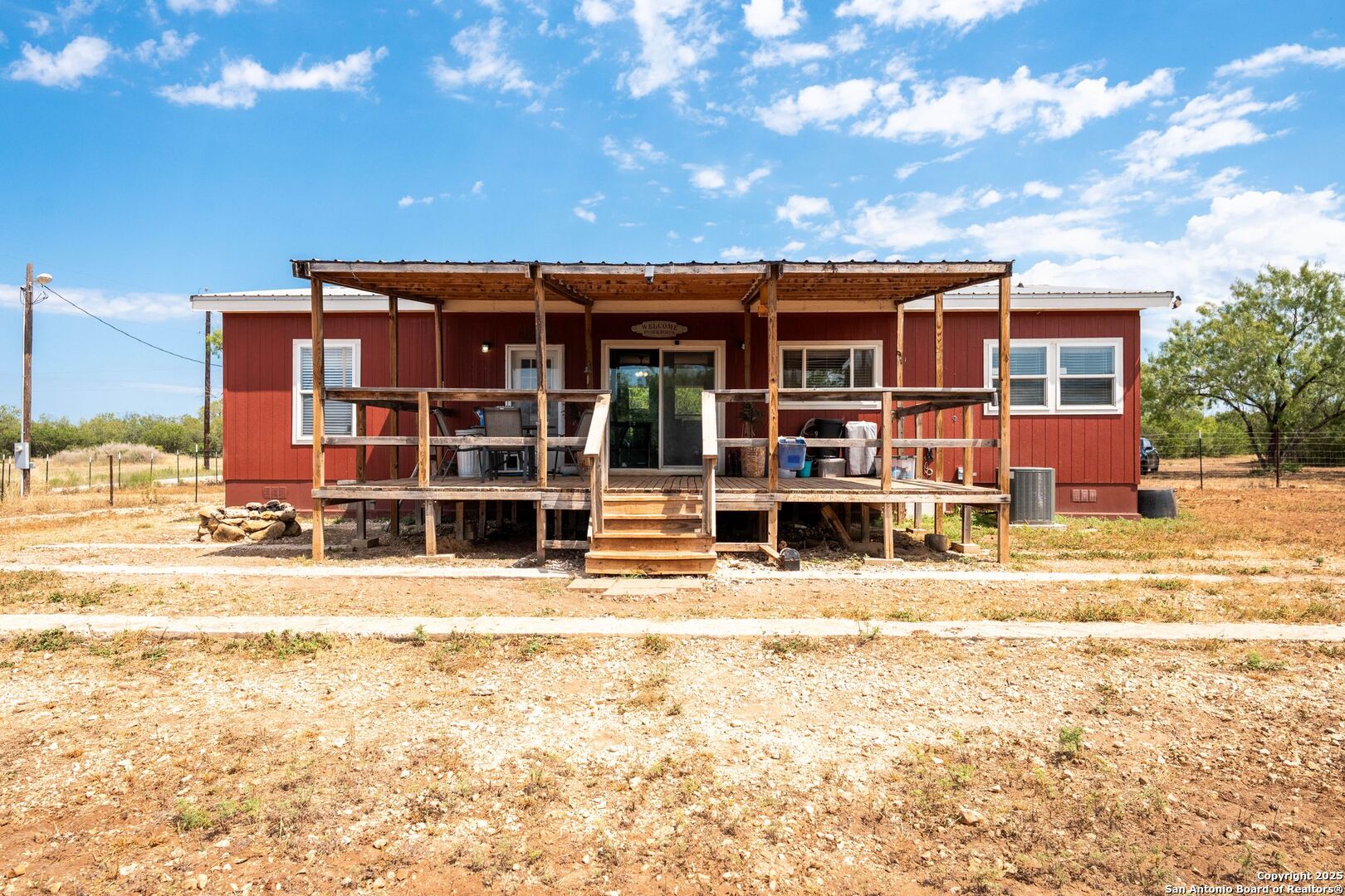 1979 County Road 651 Devine, TX 78016 - Photo 29 of 52 a front view of a house with a yard
