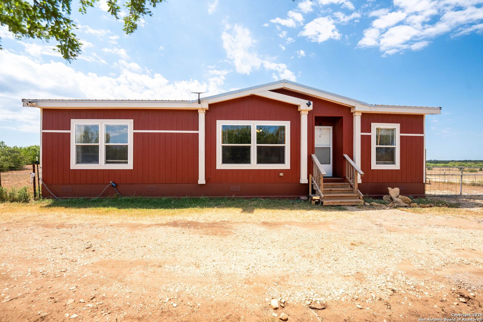 1979 County Road 651 Devine, TX 78016 - Photo 3 of 52 a view of a house with a yard