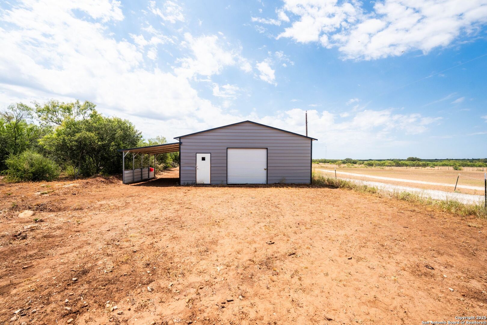 1979 County Road 651 Devine, TX 78016 - Photo 34 of 52 a view of a lake with a big yard