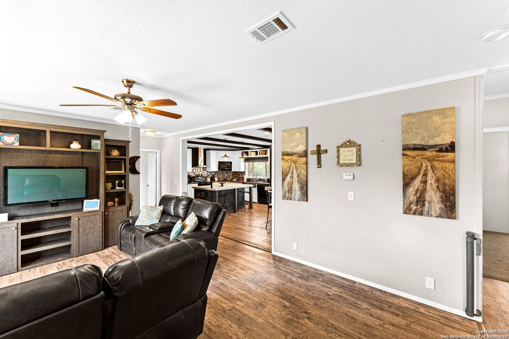 1979 County Road 651 Devine, TX 78016 - Photo 6 of 52 a living room with furniture and a flat screen tv