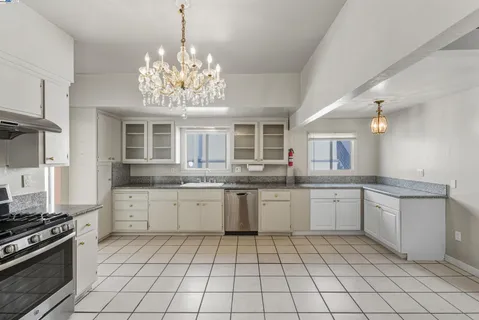 a kitchen with a sink and stove top oven