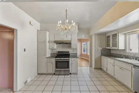 a kitchen with stainless steel appliances a stove sink and cabinets