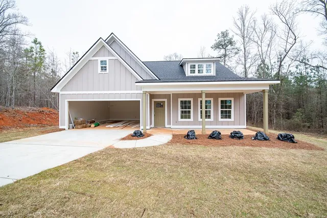 a view of a house with a yard and sitting area