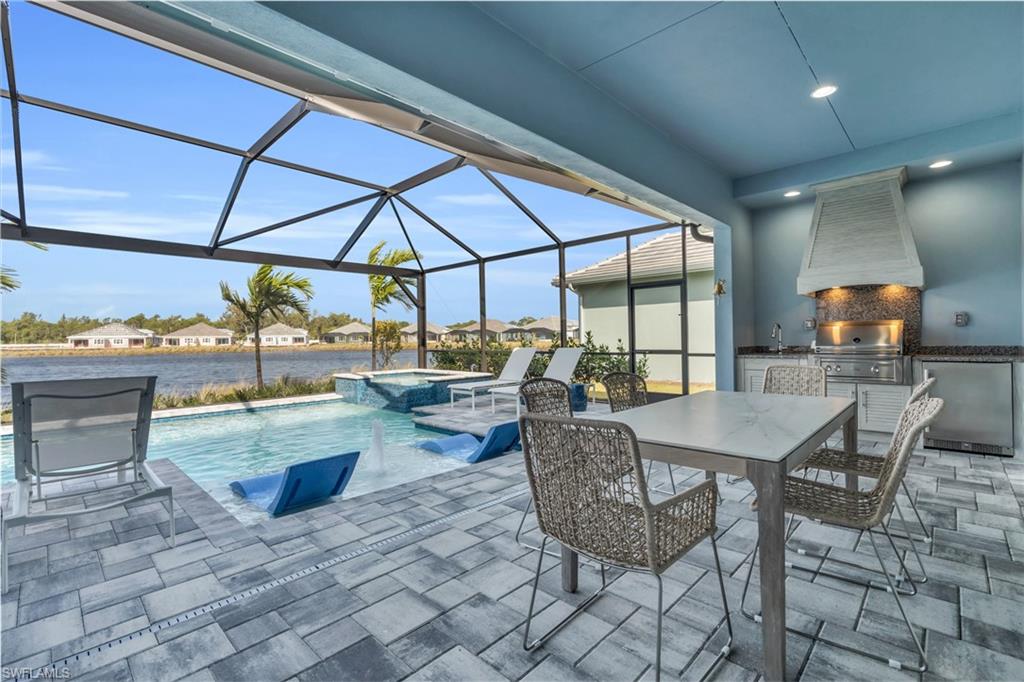 8795 Calypso Court Naples, FL 34113 - Photo 31 of 49 a view of a patio with a dining table and chairs