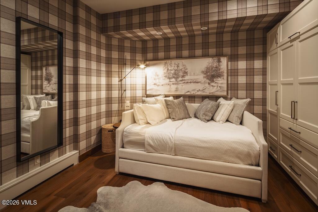 1670 Fall Ridge Road, Unit C11 Vail, CO 81657 - Photo 36 of 39 a bedroom with a bed and wooden floor