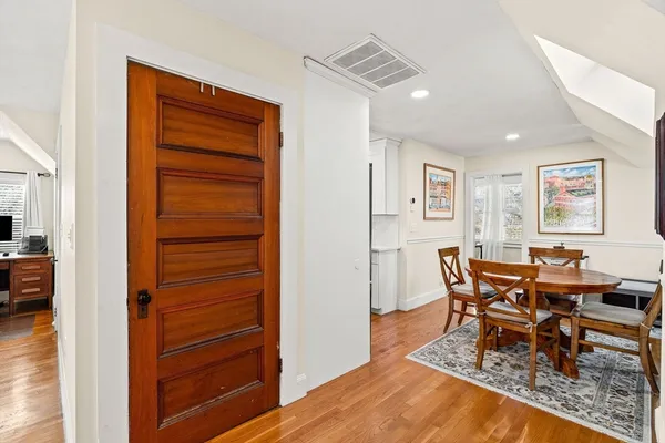 a dining room with furniture and wooden floor
