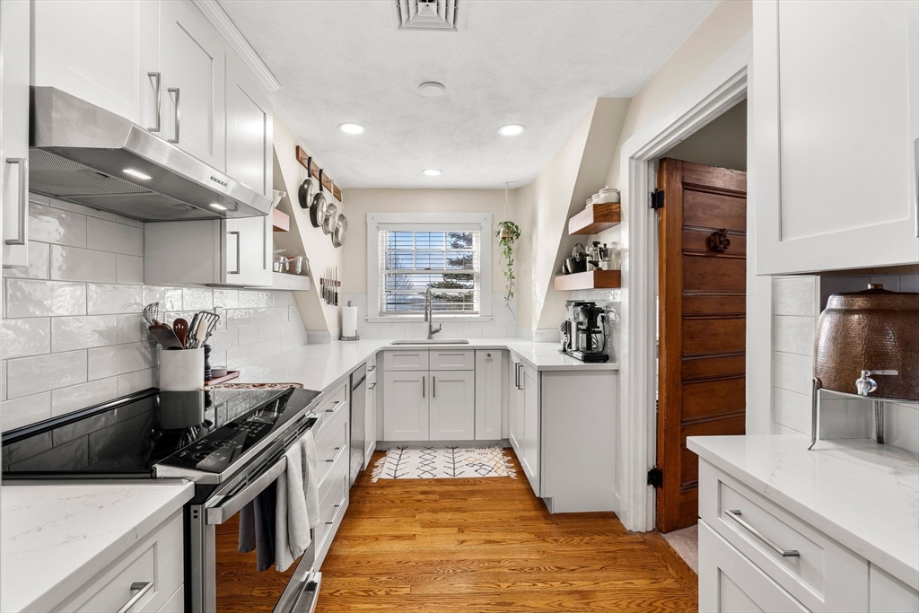28 Columbus Avenue, Unit 3 Beverly, MA 01915 - Photo 18 of 40 a kitchen with granite countertop a sink stainless steel appliances and cabinets
