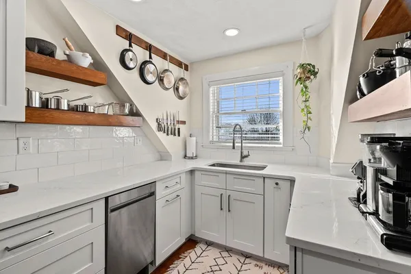 a kitchen with a sink stove and cabinets