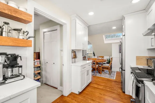 a view of a living room kitchen and a wooden floor