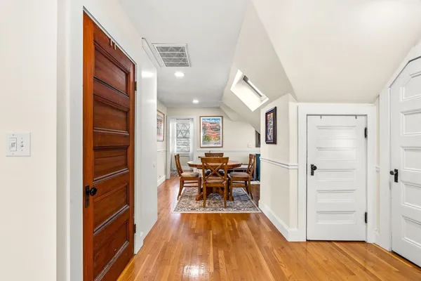 a view of a living room with furniture and wooden floor