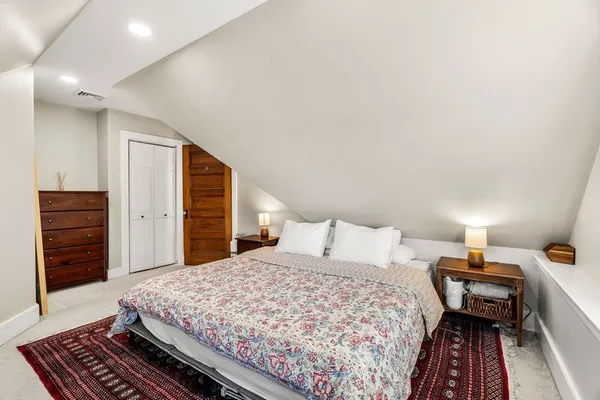 a bedroom with a bed and dresser