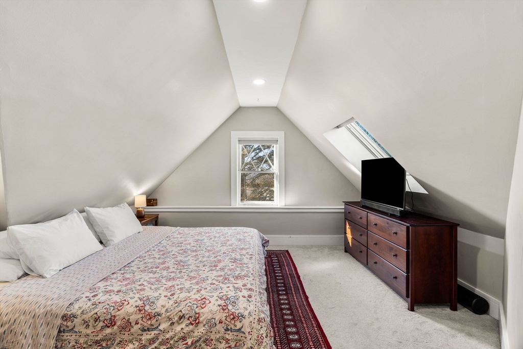 28 Columbus Avenue, Unit 3 Beverly, MA 01915 - Photo 27 of 40 a bedroom with a bed and a flat screen tv