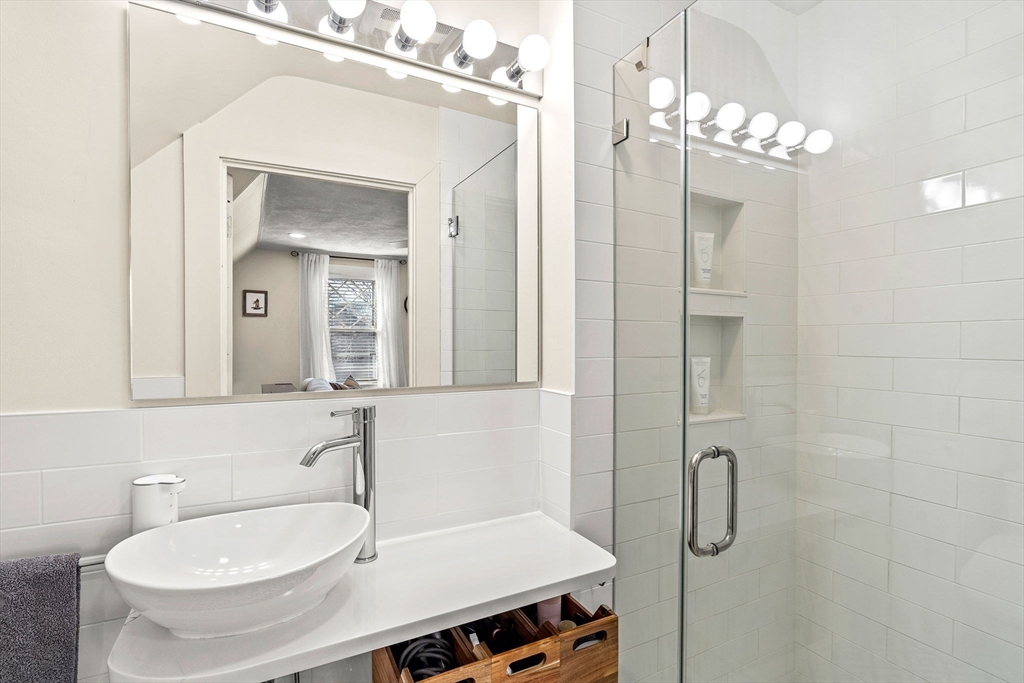 28 Columbus Avenue, Unit 3 Beverly, MA 01915 - Photo 30 of 40 a bathroom with a sink and a mirror