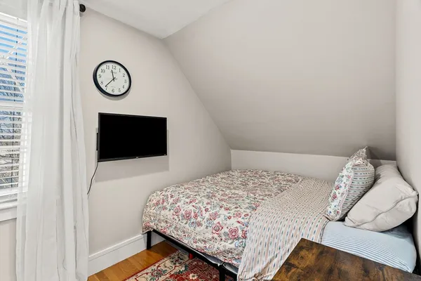 a bedroom with a bed and a television