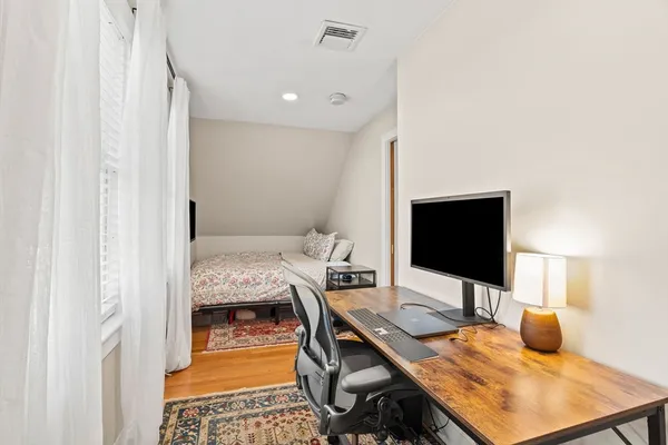 a bedroom with a workspace