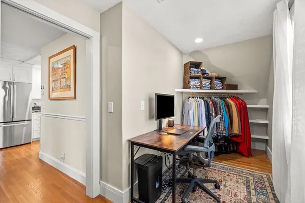 a view of walk in closet with clothes and shoes