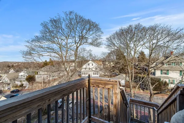 a view of a balcony with wooden fence