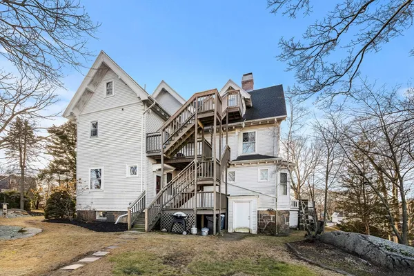 a view of a white house with a yard