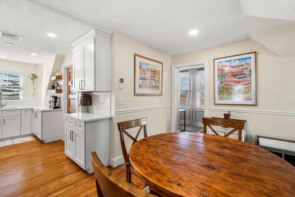a view of a dining room with furniture and wooden floor