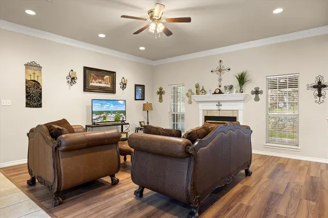 a living room with furniture a flat screen tv and a fireplace