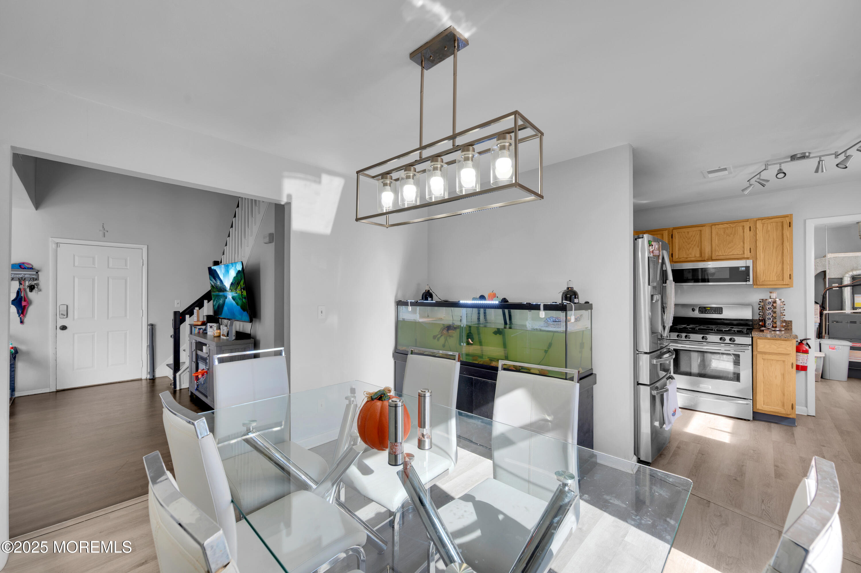 21 Shelli Terrace Barnegat, NJ 08005 - Photo 10 of 42 a living room with furniture a dining table and a chandelier