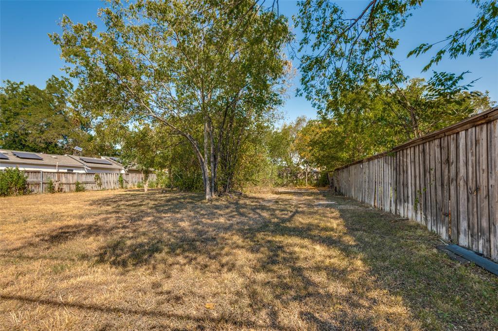 5115 Spruce Street Dallas, TX 75211 - Photo 3 of 10 a view of a yard with plants and large trees