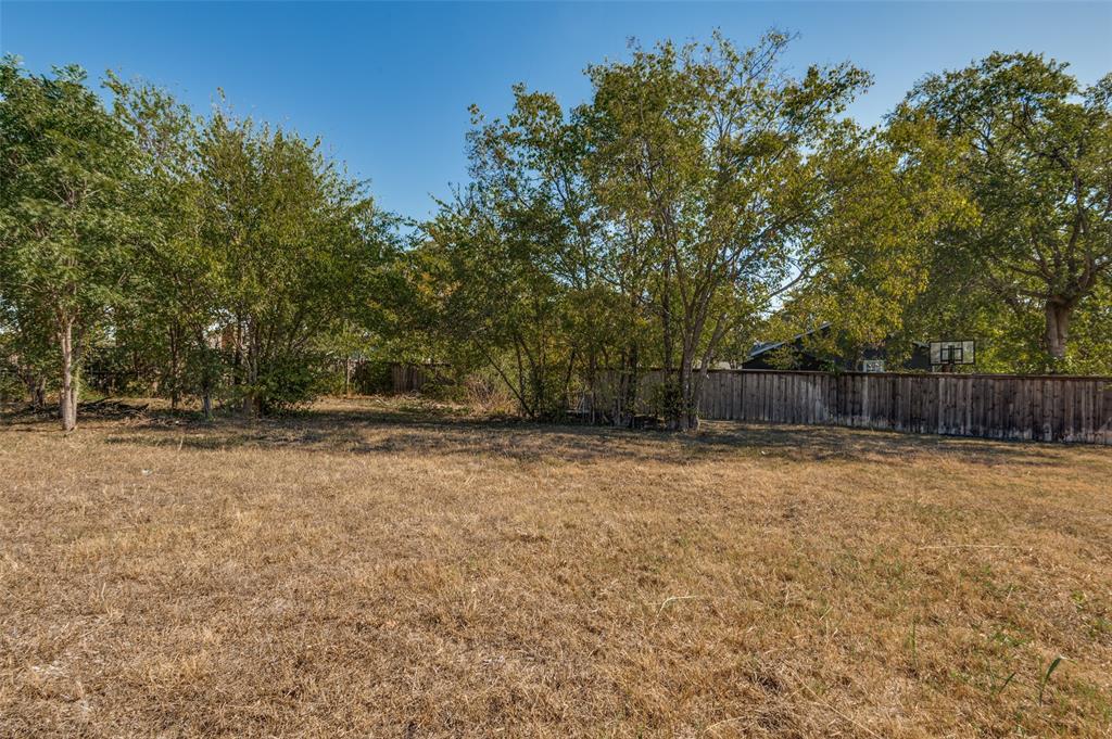 5115 Spruce Street Dallas, TX 75211 - Photo 4 of 10 a backyard of a house with trees