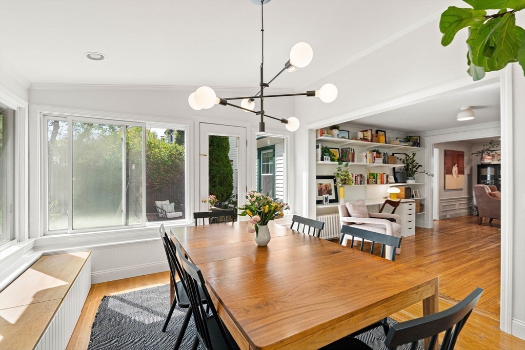34 Avalon Road Milton, MA 02186 - Photo 22 of 42 a dining room with furniture potted plants and wooden floor