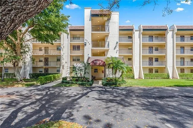 a front view of a residential apartment building with a yard