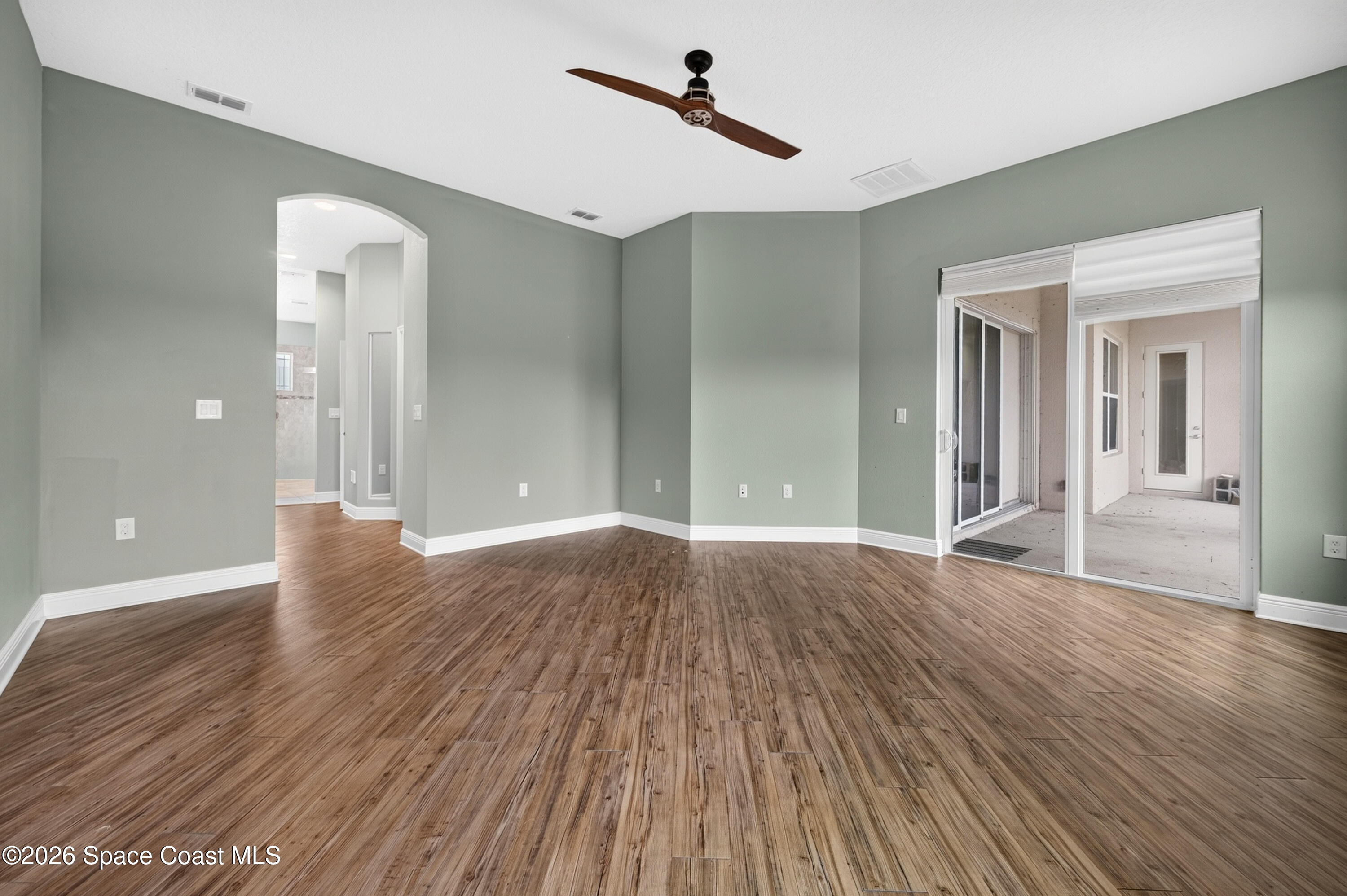 1475 Dalbora Road Merritt Island, FL 32953 - Photo 32 of 57 wooden floor in an empty room with a window