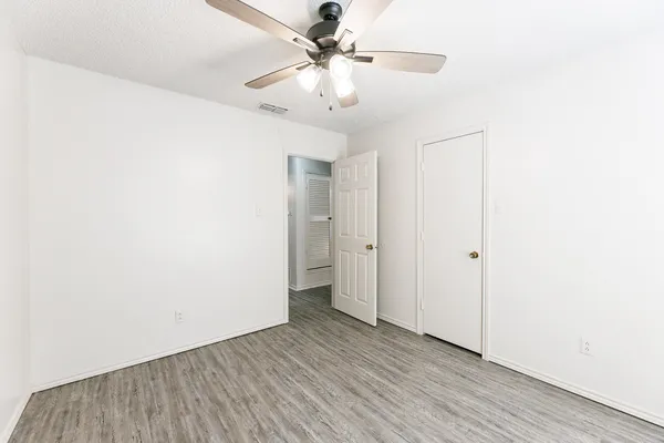 a view of an empty room with a ceiling fan