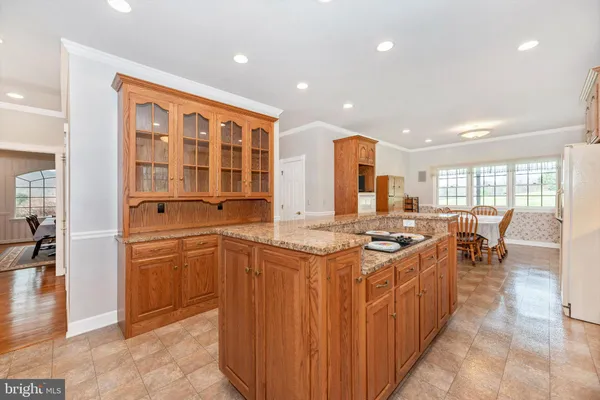 a kitchen with stainless steel appliances granite countertop a stove and cabinets