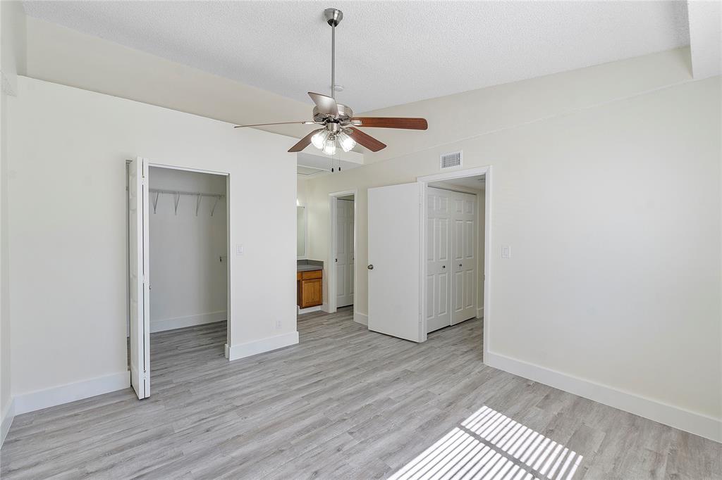 931 Lyons Road, Unit 4204 Coconut Creek, FL 33063 - Photo 4 of 13 a view of a room with wooden floor and a ceiling fan