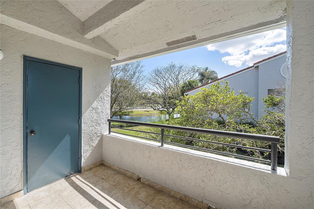 931 Lyons Road, Unit 4204 Coconut Creek, FL 33063 - Photo 7 of 13 a view of a balcony with furniture