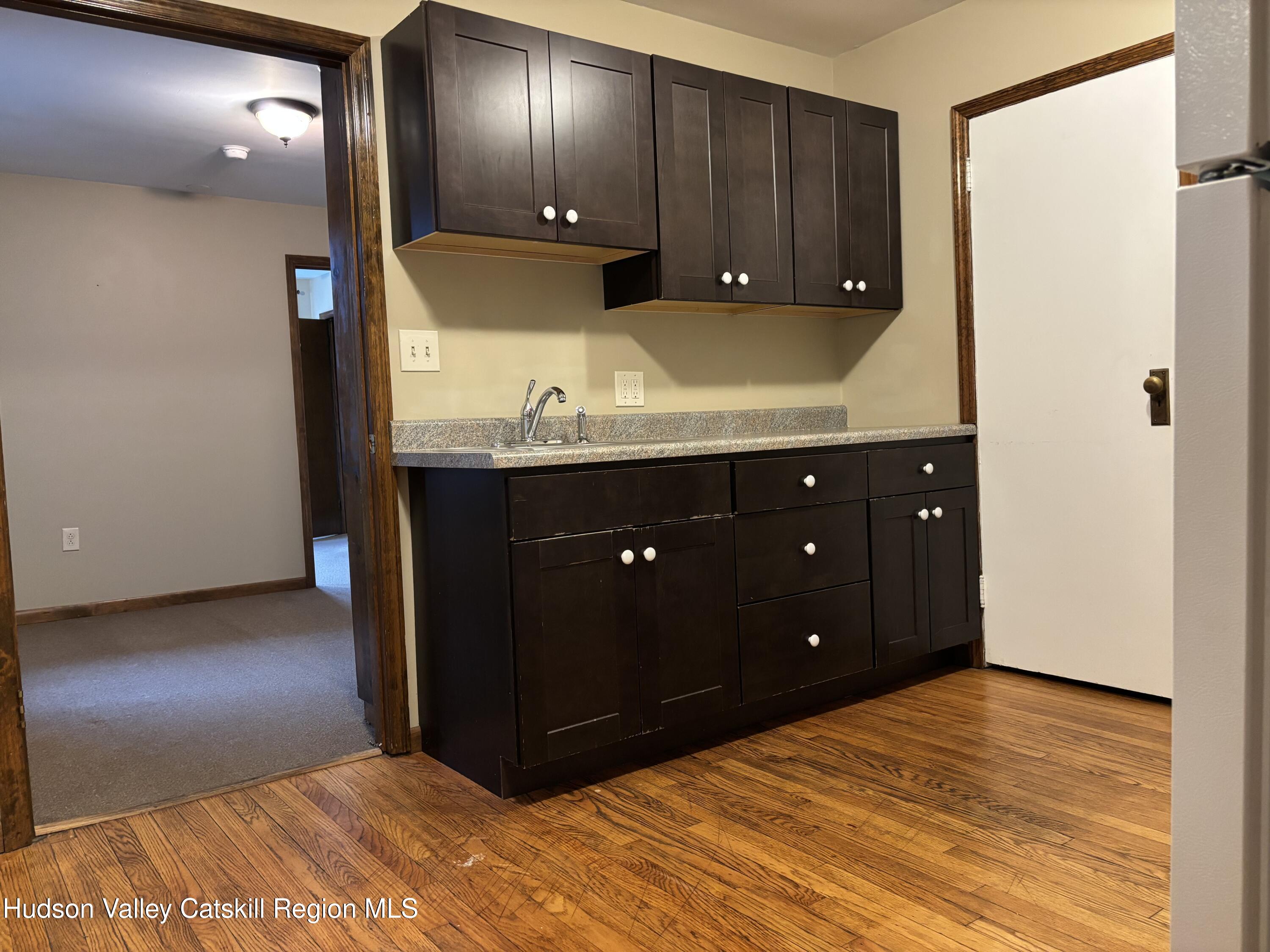 261 Fair Street, Unit B Kingston, NY 12401 - Photo 11 of 18 a room with a dresser and a mirror