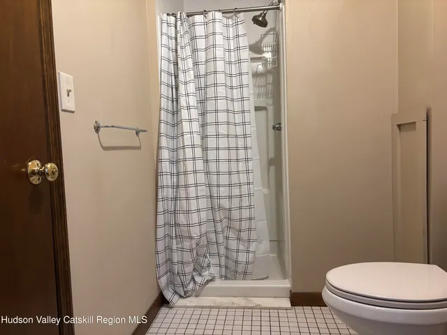 a bathroom with a toilet and a shower