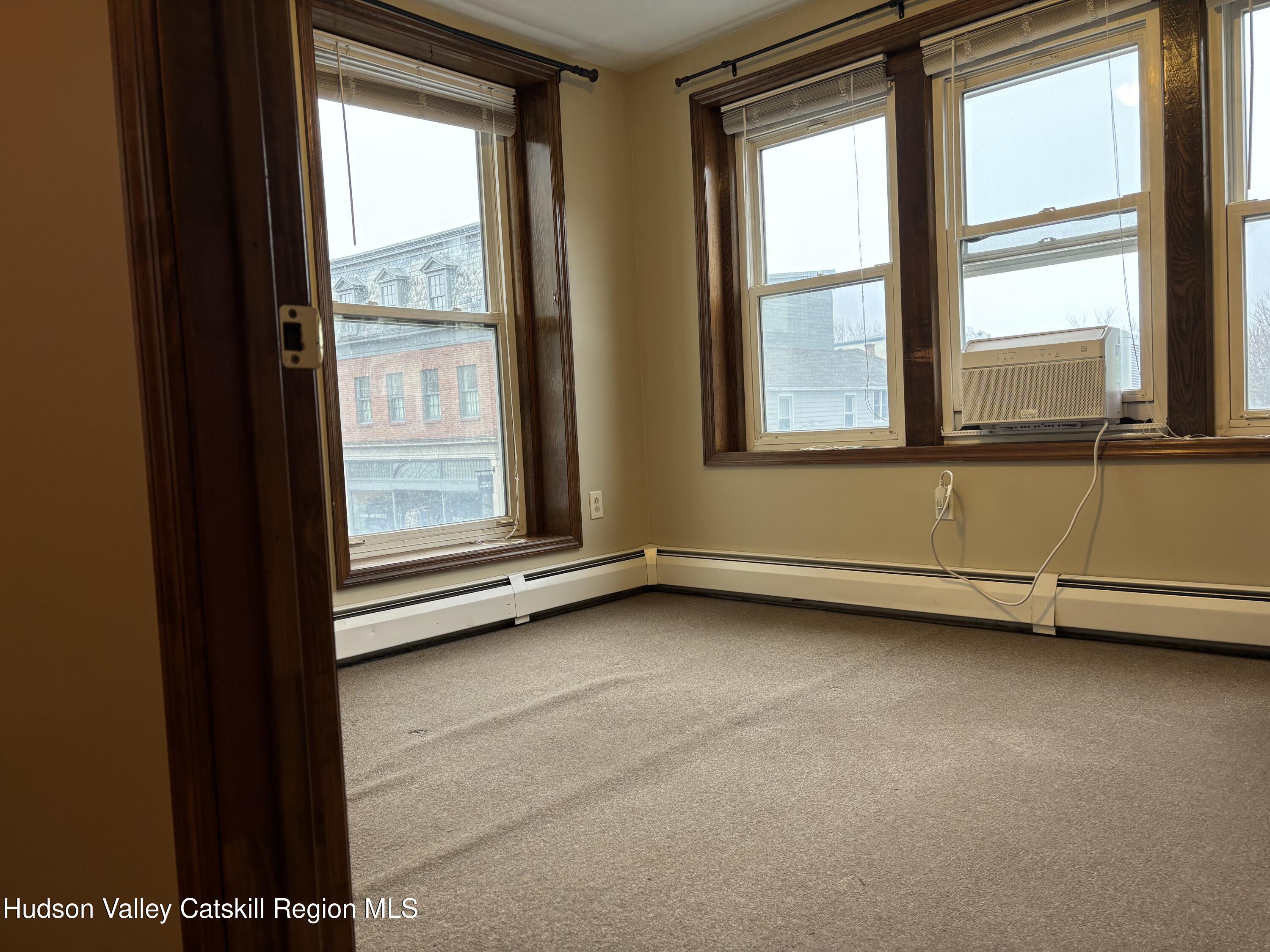261 Fair Street, Unit B Kingston, NY 12401 - Photo 2 of 18 a view of an empty room with a window