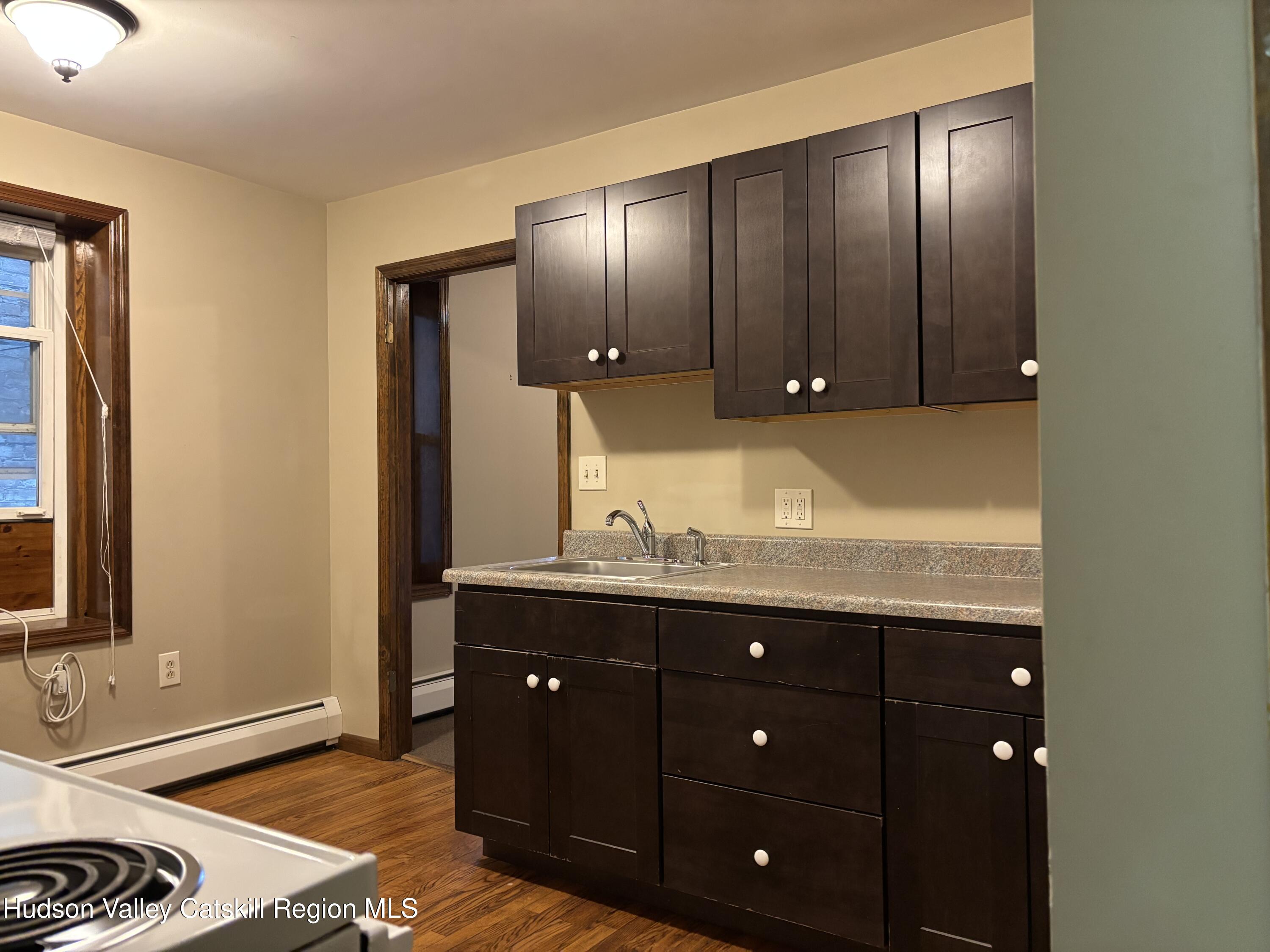 261 Fair Street, Unit B Kingston, NY 12401 - Photo 10 of 18 a bathroom with a granite countertop sink and a mirror