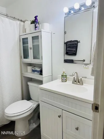 a bathroom with a sink a toilet and mirror