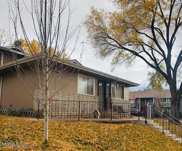 a view of a house with a large tree