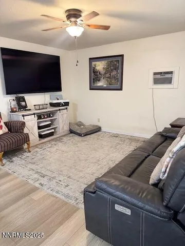 a bedroom with furniture and a flat screen tv