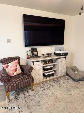 a bedroom with a bed and flat screen tv