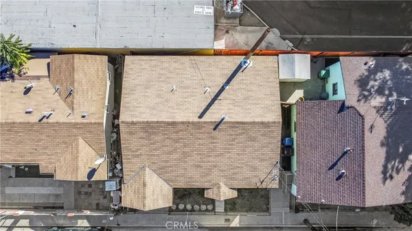 an aerial view of a residential houses with city view