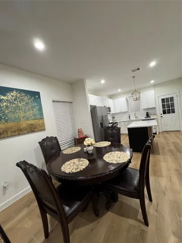 a dining room with furniture and window