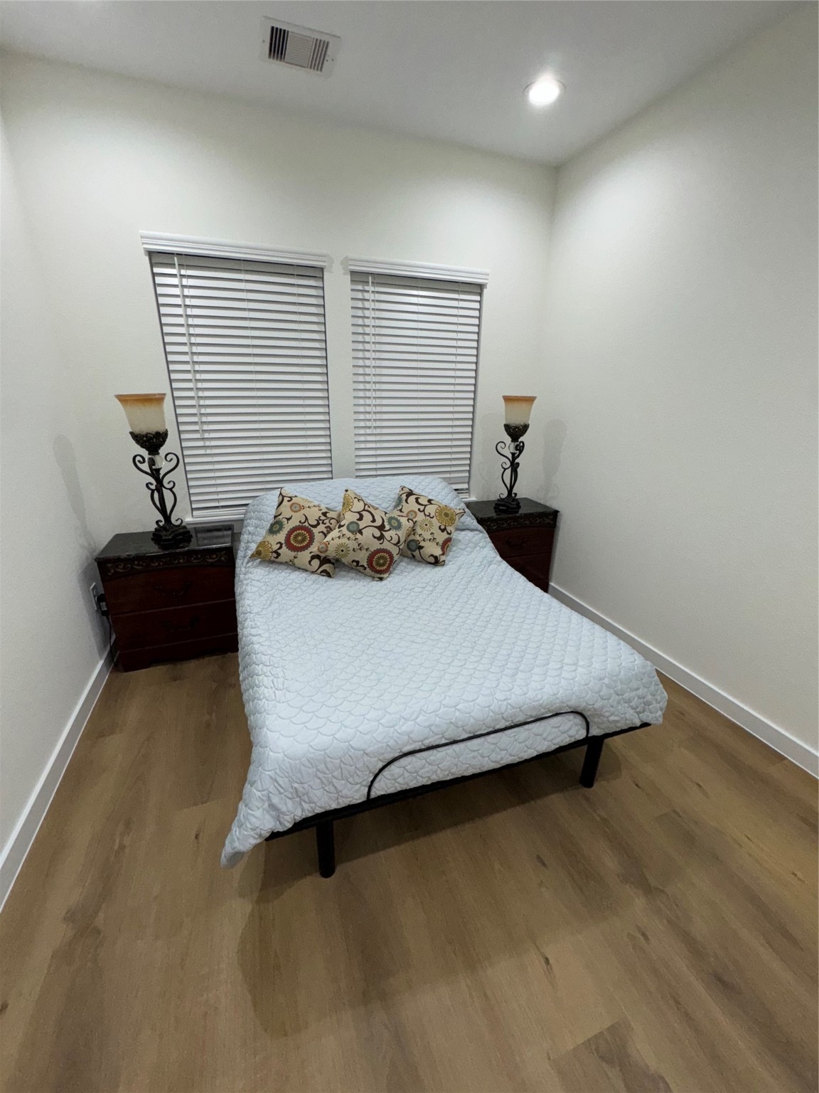 8113 Miley Street Houston, TX 77028 - Photo 7 of 8 a bedroom with a bed and a potted plant