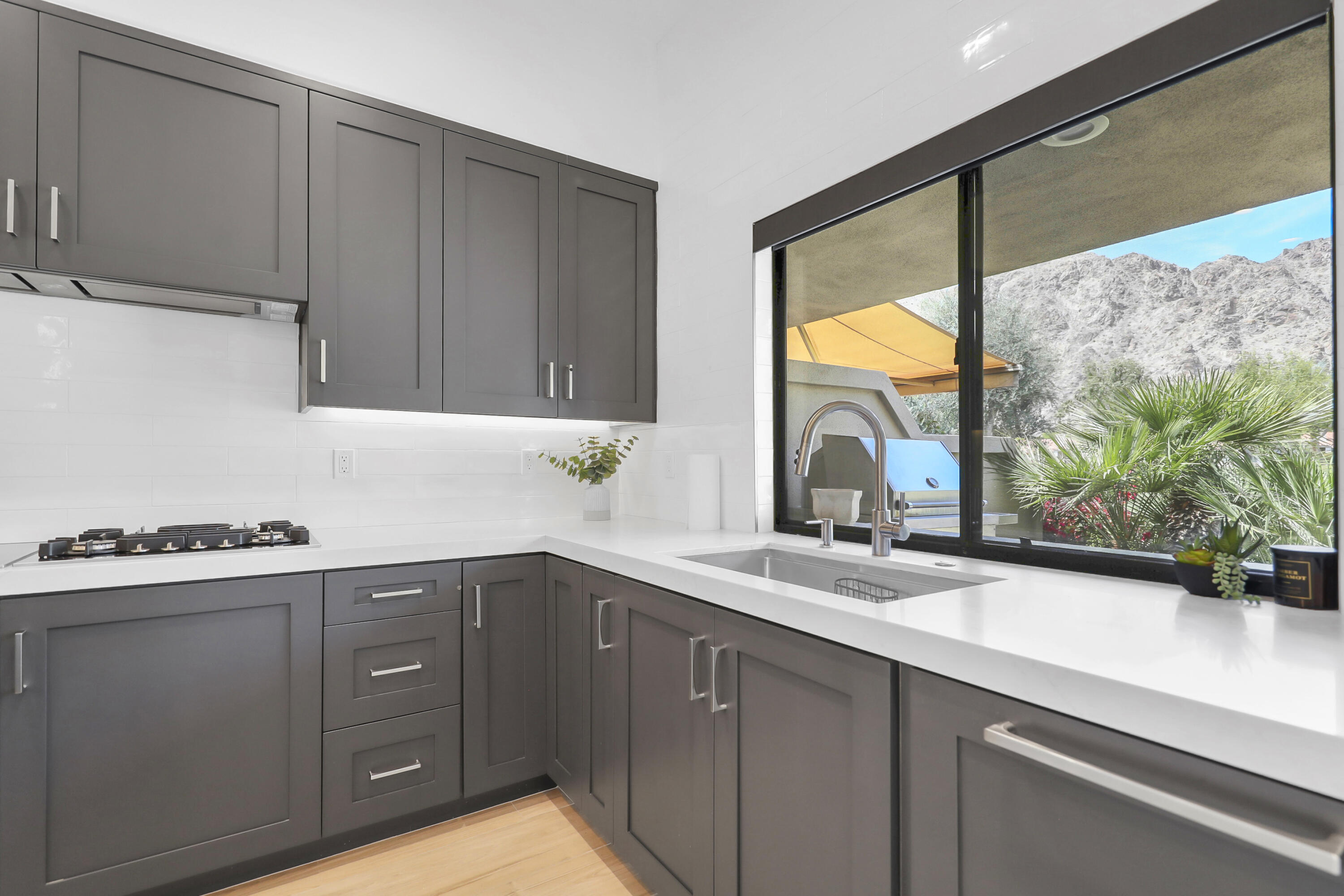 79754 Arnold Palmer La Quinta, CA 92253 - Photo 14 of 38 a kitchen with a sink and a window