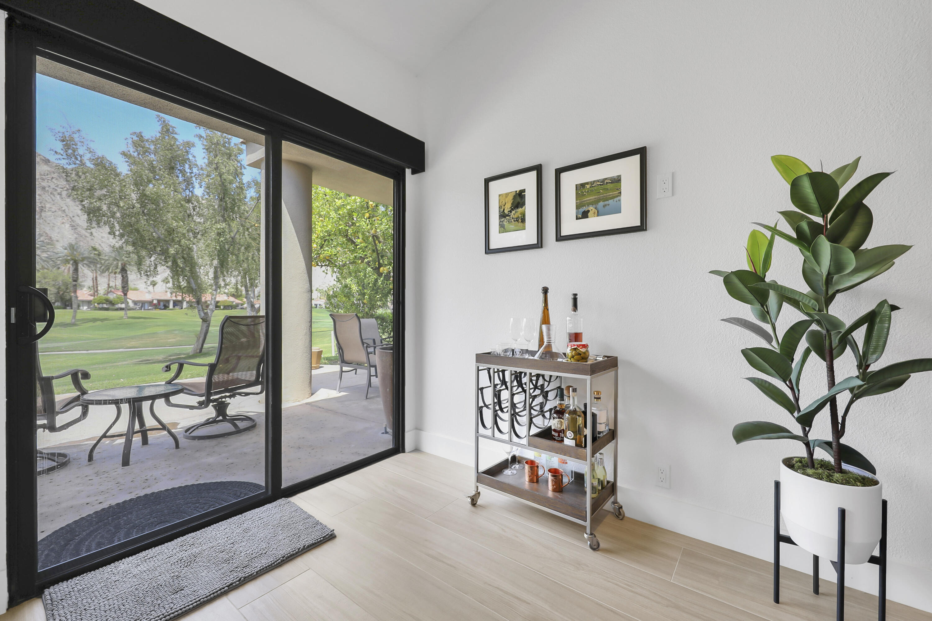 79754 Arnold Palmer La Quinta, CA 92253 - Photo 16 of 38 a living room filled with furniture and a potted plant