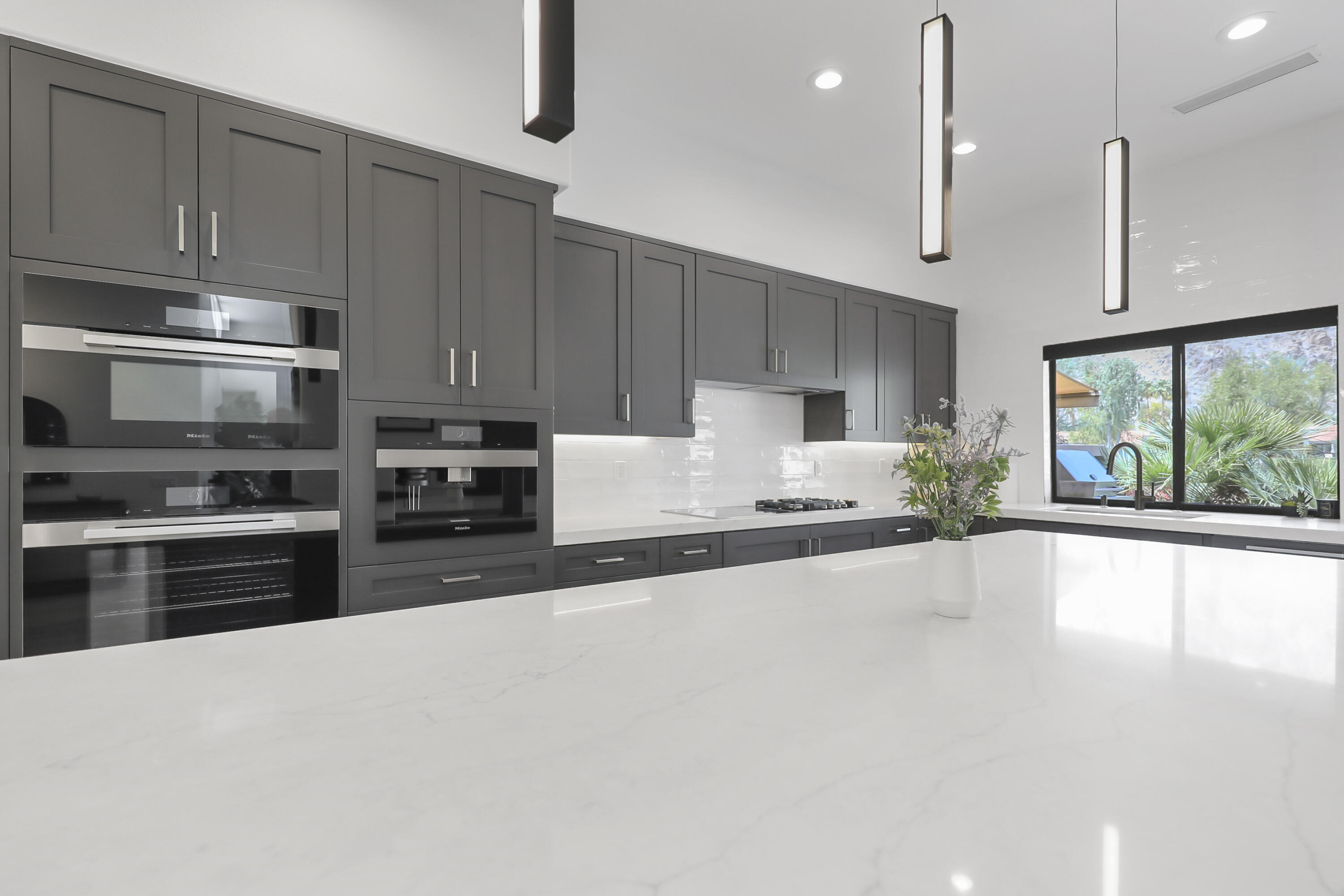 79754 Arnold Palmer La Quinta, CA 92253 - Photo 17 of 38 a large kitchen with stainless steel appliances a large counter top stove and cabinets