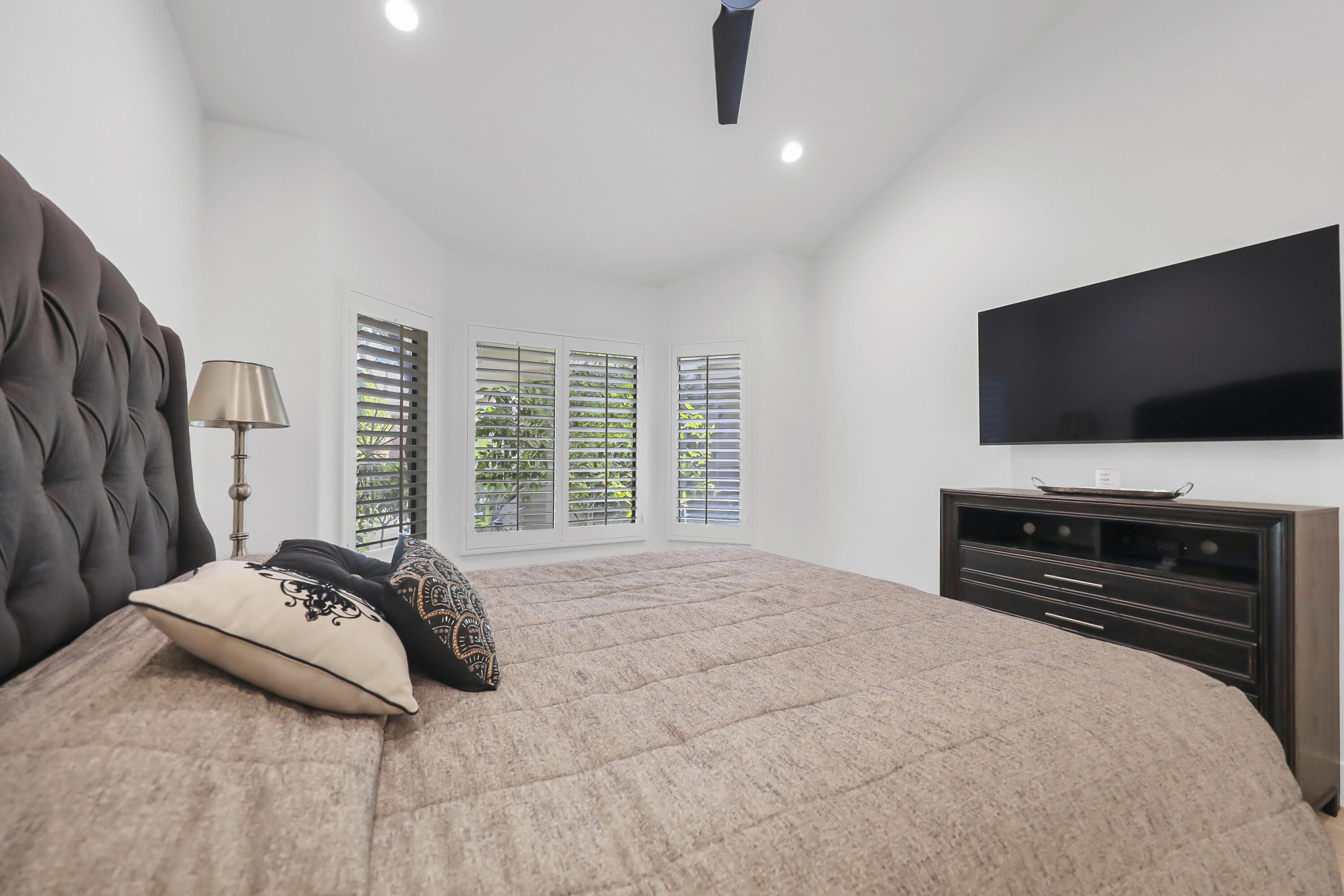 79754 Arnold Palmer La Quinta, CA 92253 - Photo 20 of 38 a bedroom with a bed and a flat screen tv